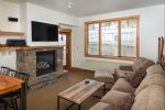 The living room features oversized couch, gas fireplace & walkout access to the ski in ski out patio.